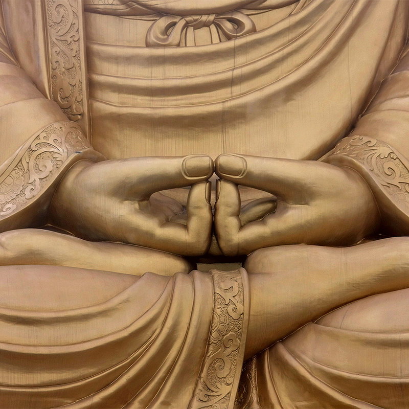 golden statue, meditation pose, hand gesture, robe detailing, stone sculpture