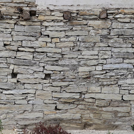         Stone optics photo wallpaper with bright dry stone wall
    