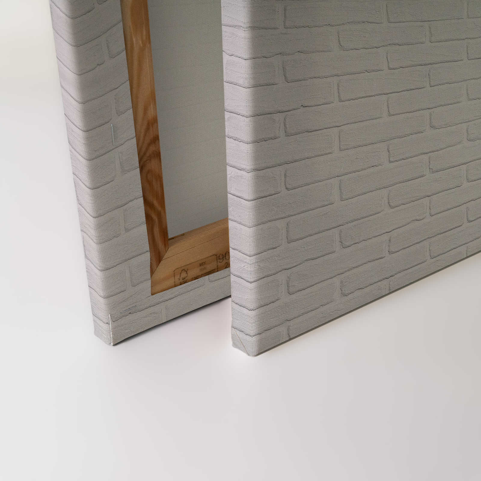             Leinwandbild mit kleinen Blätterranken auf einer Steinwand – 0,90 m x 0,60 m
        