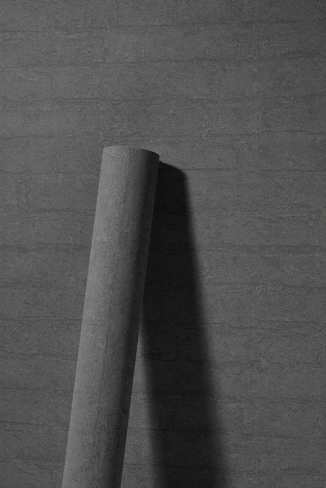             Vliestapete in dunkler Steinoptik mit Backsteinen – anthrazit
        