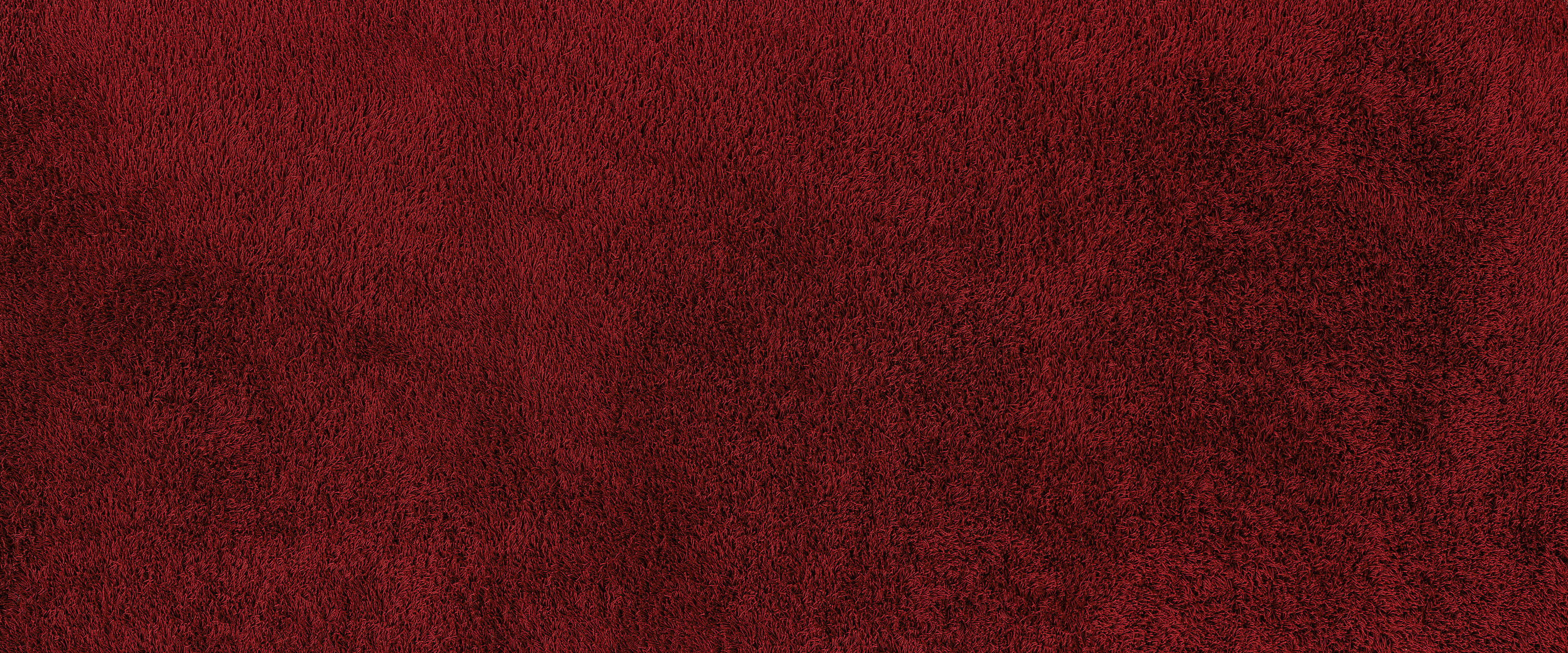             Fototapete Detailaufnahme eines roten Teppichs
        