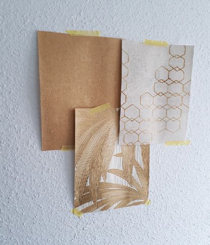 selection of wallpaper patterns in comparison on the wall