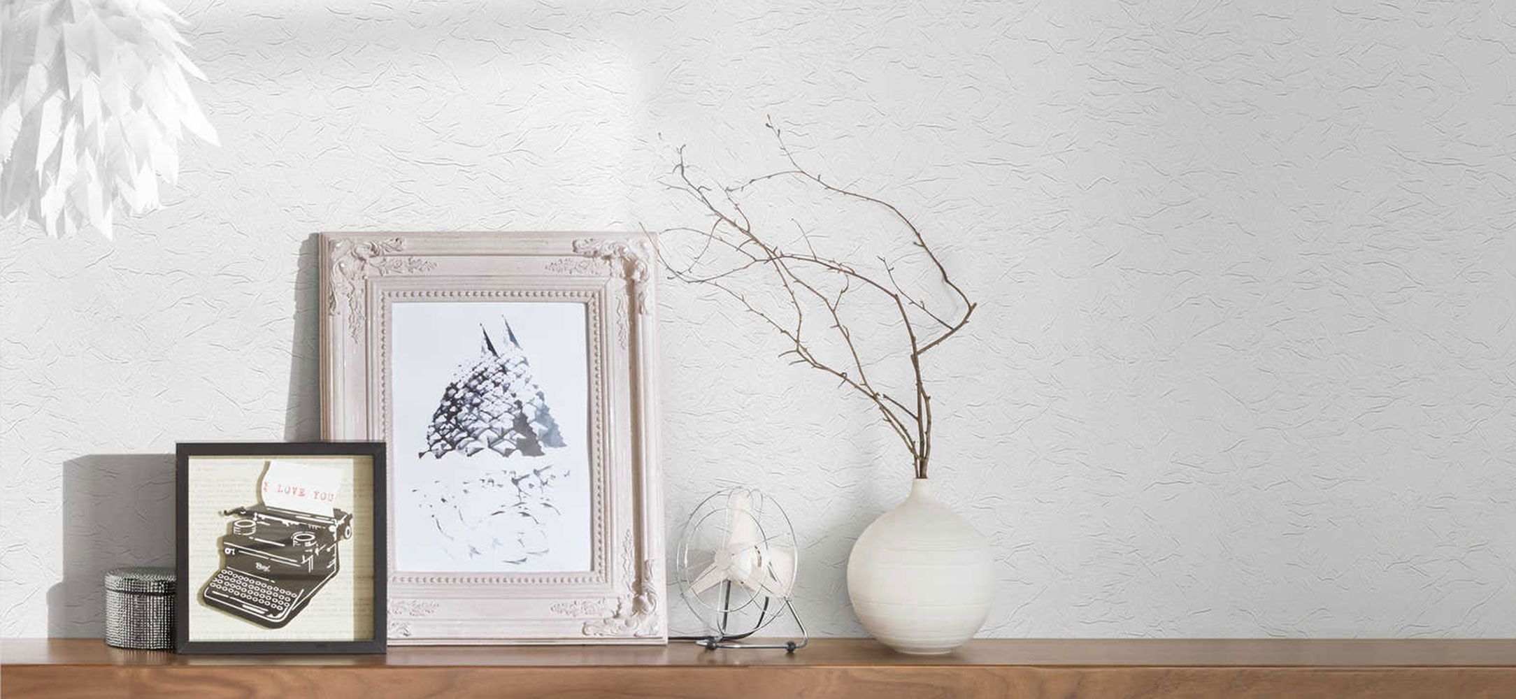 Pictures in front of woodchip wallpaper 