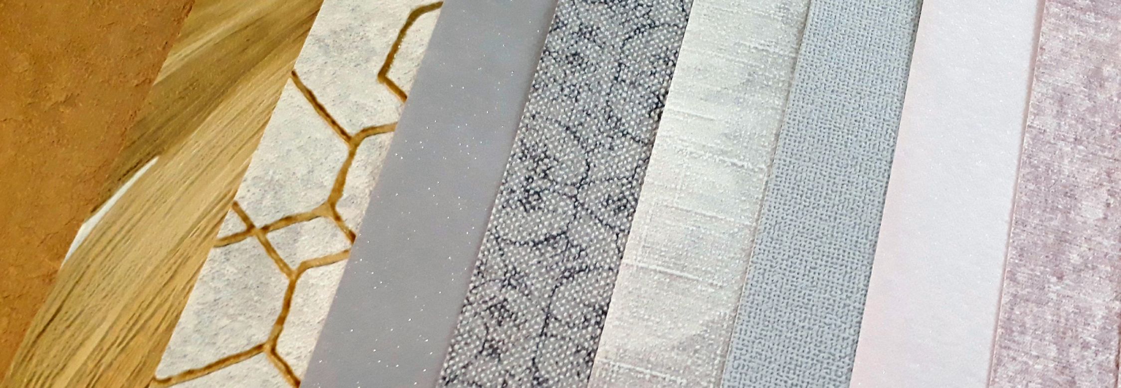 selection of wallpaper patterns laid out in a fan