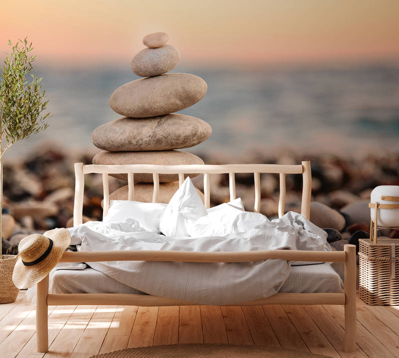             Fototapete mit Steinturm am Meer – Grau, Blau, Orange
        